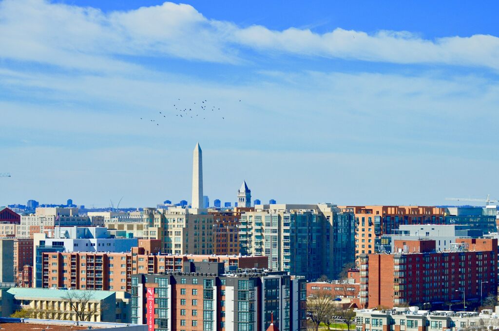 An aerial view of DC with several office buildings and the Washington Monument.