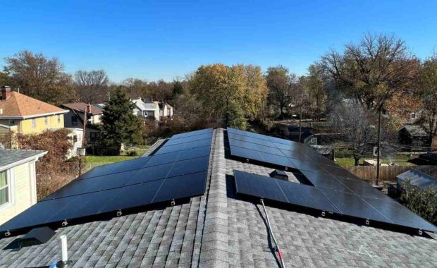 Solar panels on a pitched shingle roof.