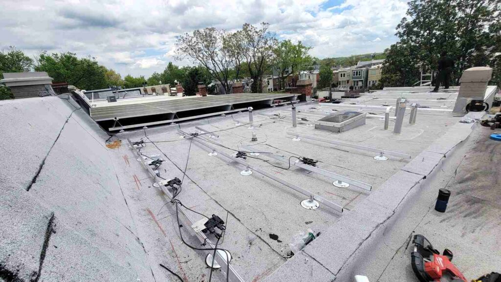 Solar attachments on a gray flat roof.