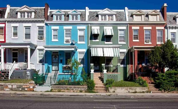 Brick row houses painted in bright colors in Washington, DC.