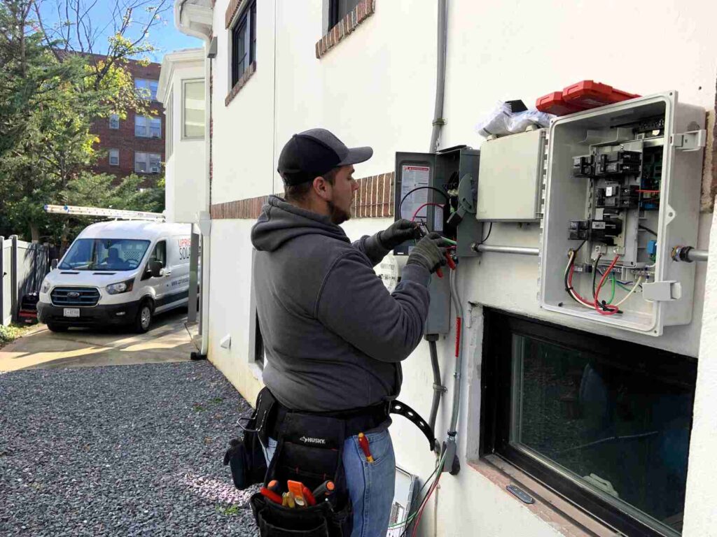 An electrician works on wiring.
