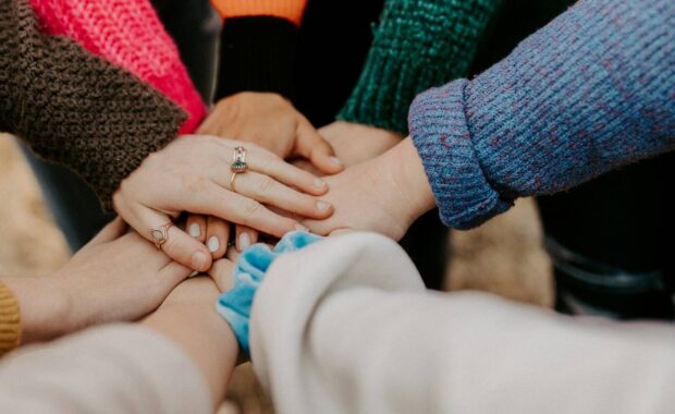 Women's hands together.