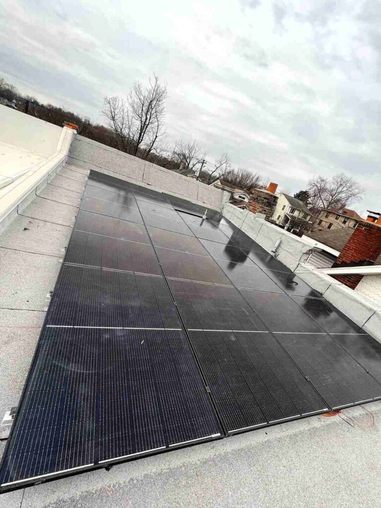 Solar panels on a gray flat roof.