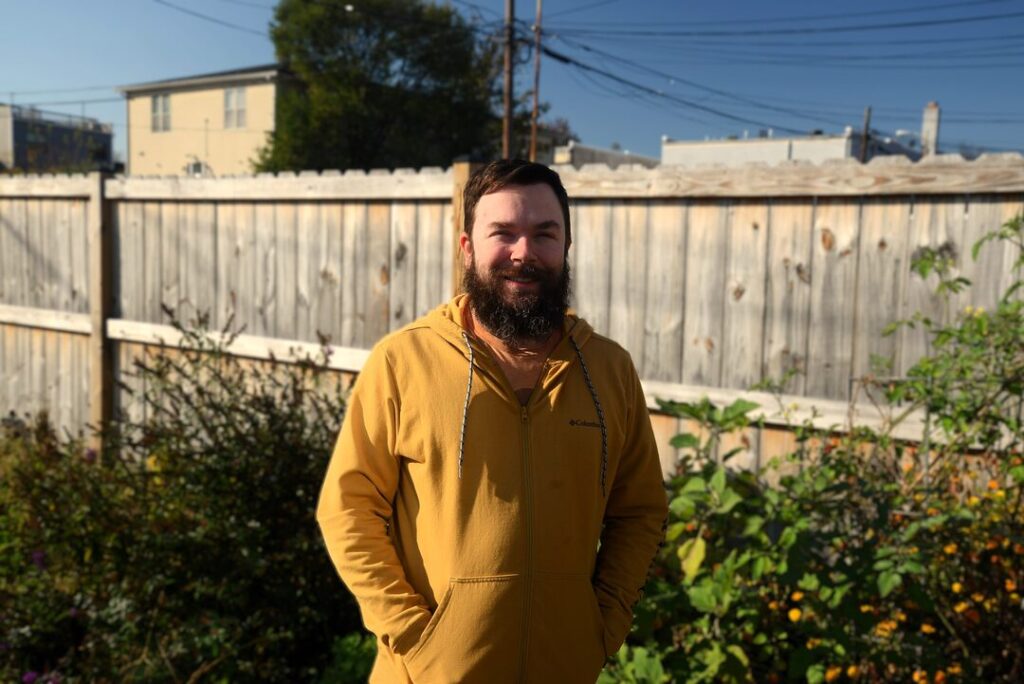 An Uprise customer stands in his Northeast backyard.