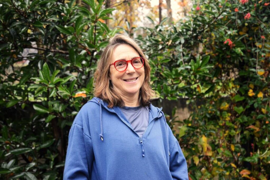 Uprise customer Tracy Warren stands in her Brookland backyard garden.