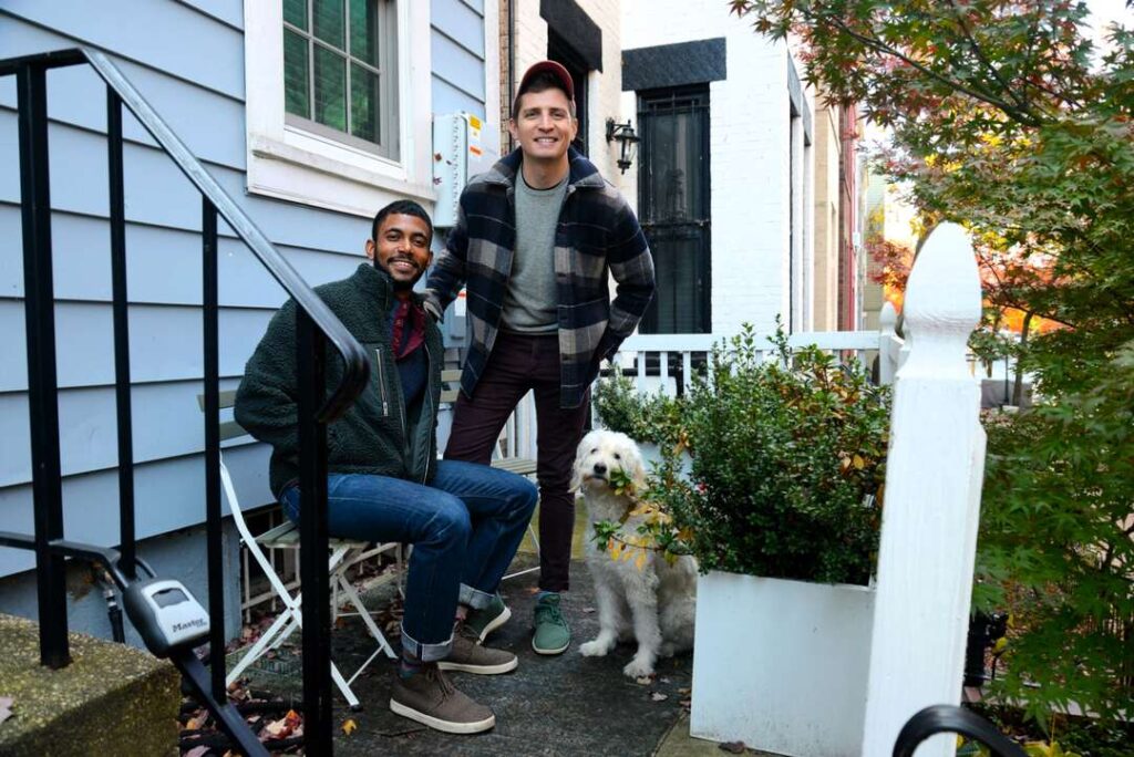 Matt and Lawrence with dog Bondi on their front porch.