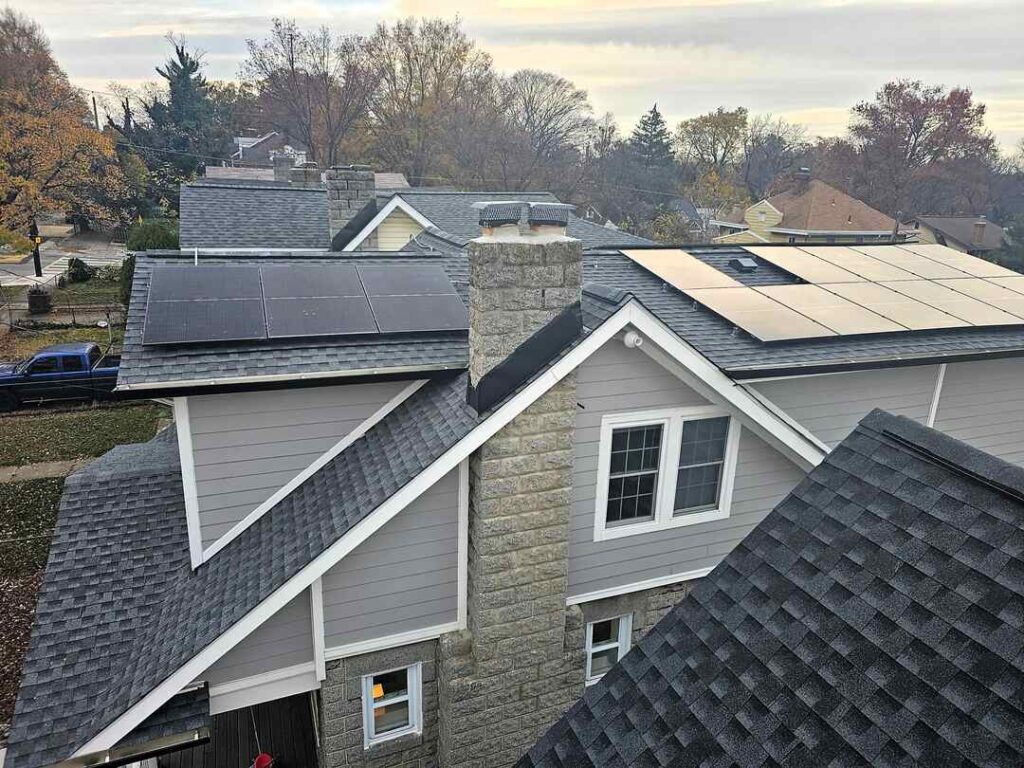 Solar panels on a shingle roof on a cloudy day.