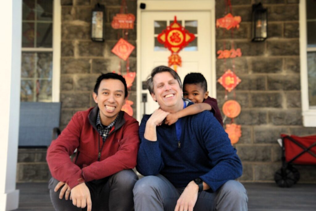 A family of three on a front porch in Washington, DC.