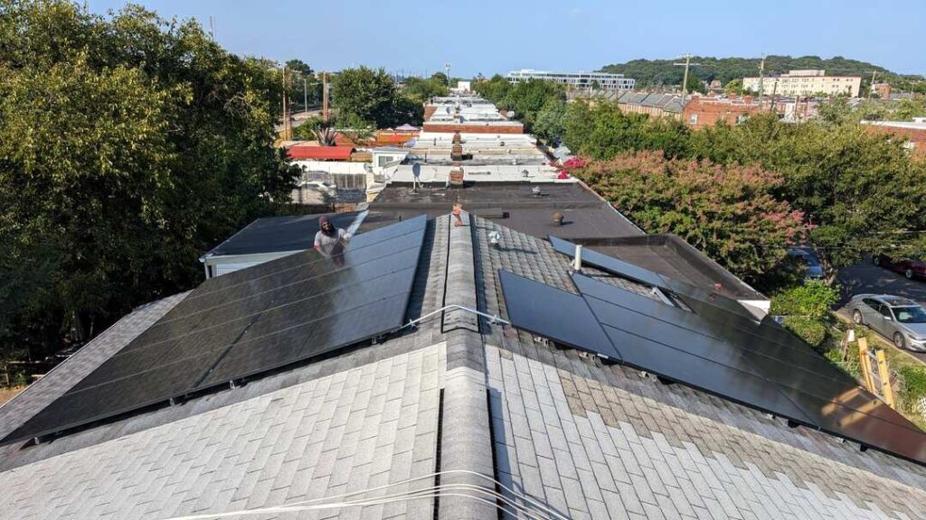 Black panels on a light gray pitched roof.