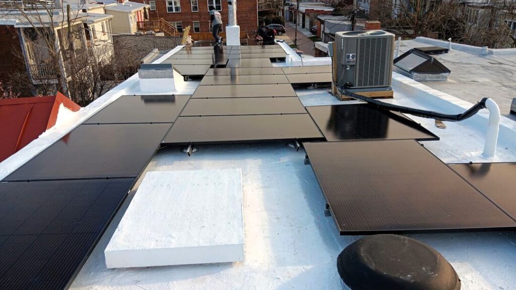 Solar panels on a white flat roof in Capitol Hill.