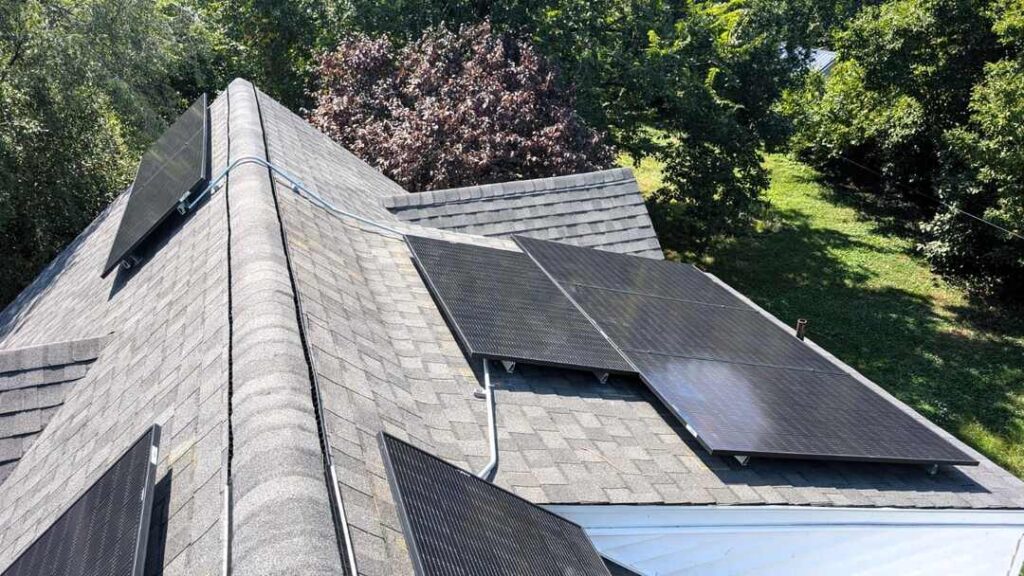 A pitched roof with solar panels on multiple sides.