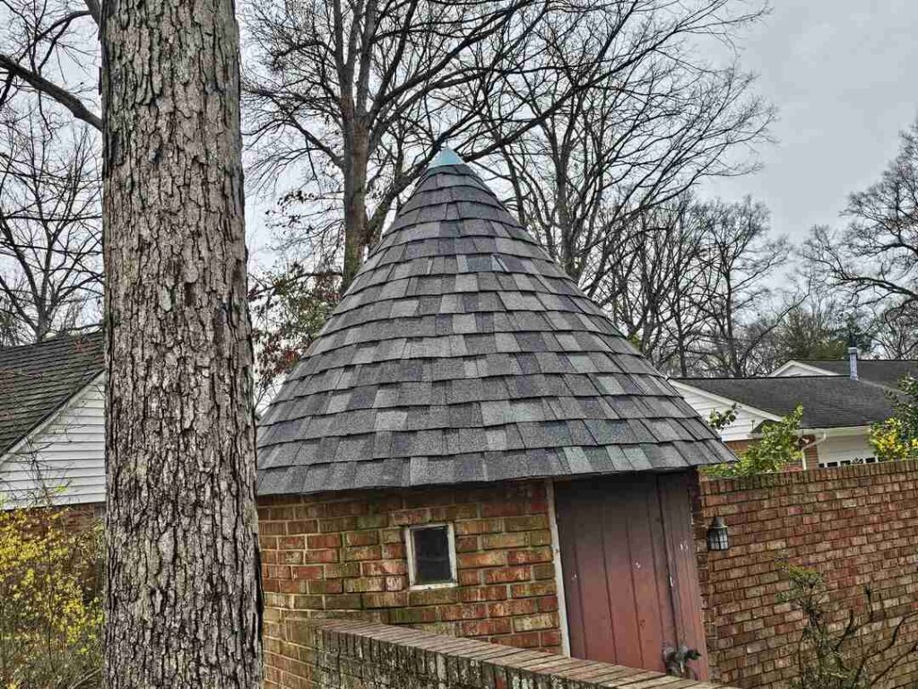 A round shed with new architectural shingles.