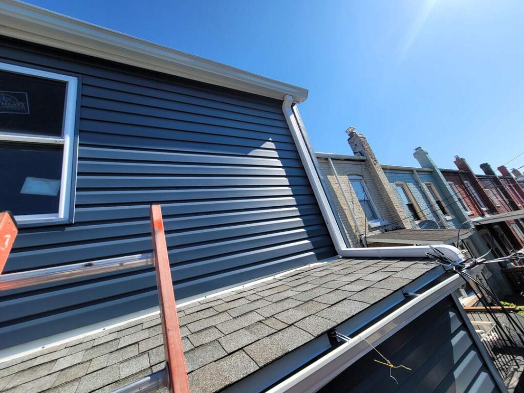 Blue siding on a DC home. You can also see the architectural shingles from this roofing project.