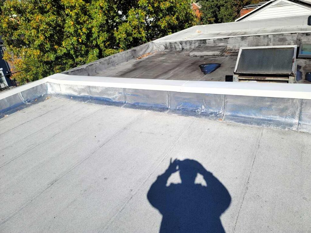 Two-ply modified roofing on a flat roof.