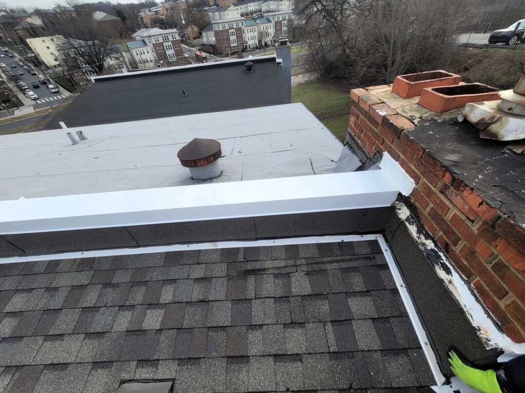 Architectural shingles with polyglass flashing and a white coping cap.