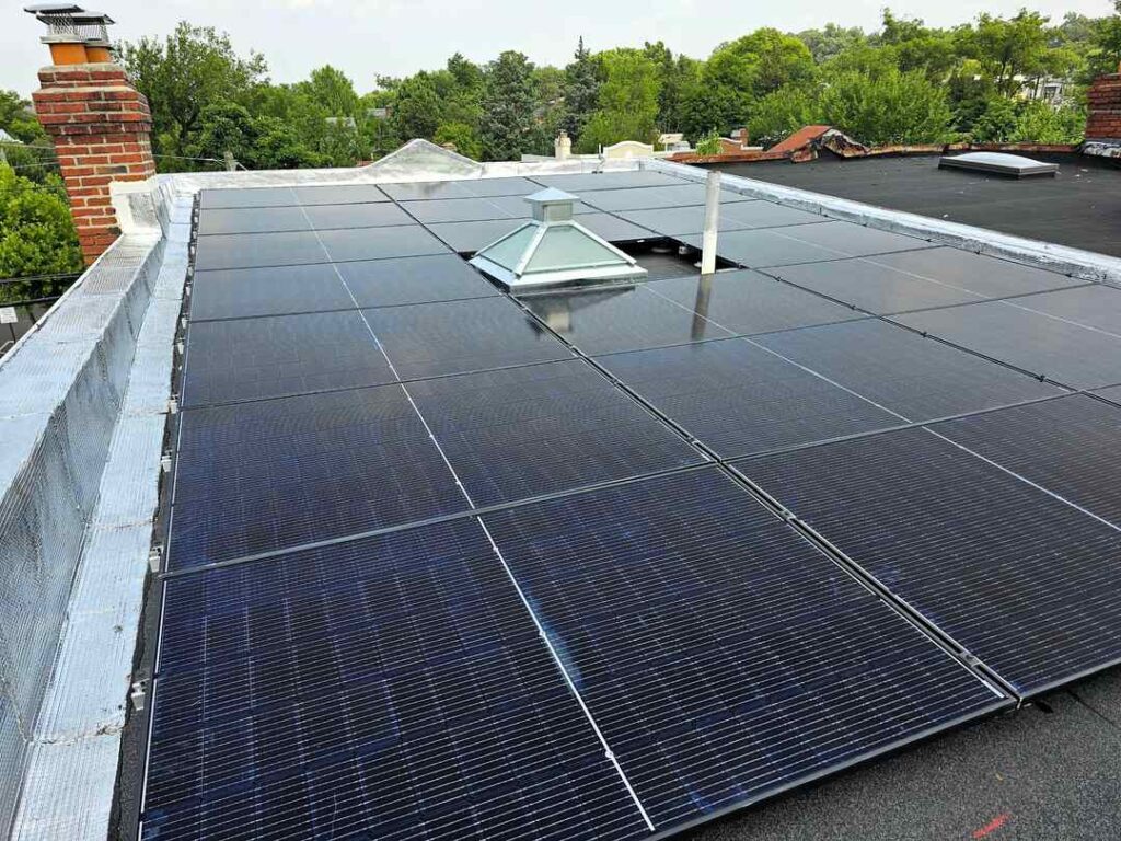 Solar panels on a flat roof installed by Uprise Solar.