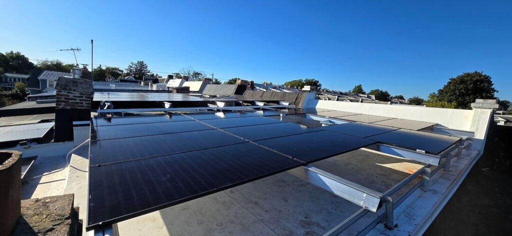 Solar panels under a clear blue sky.