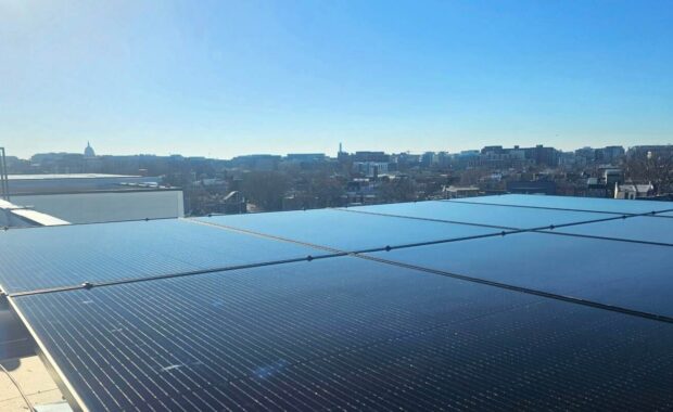 A solar array with the Washington, DC skyline in the background.