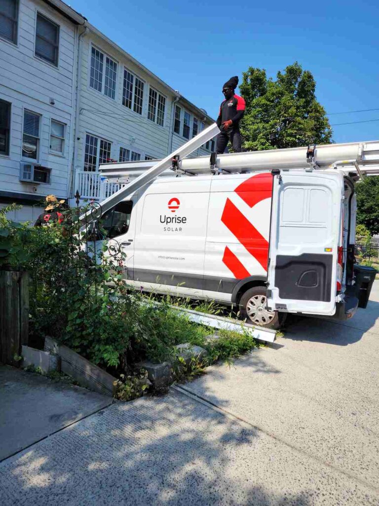 The Uprise Solar truck parked in an alley as the crew unloads equipment.