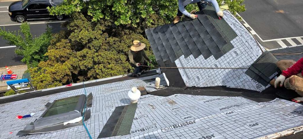 Roofers reroof a pitched roof in Northwest DC.