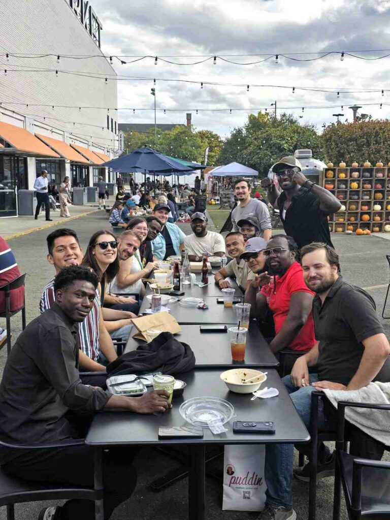 The Uprise Solar team eats lunch outside at Union Market.