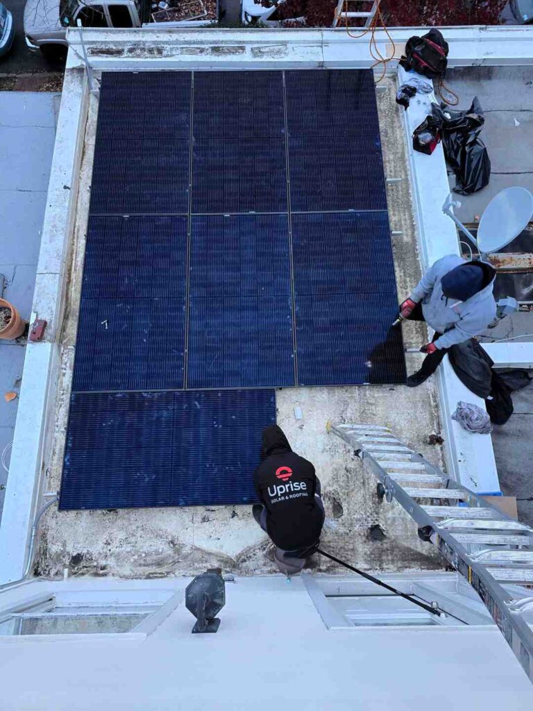 Two solar installers put the finishing touches on a solar array.