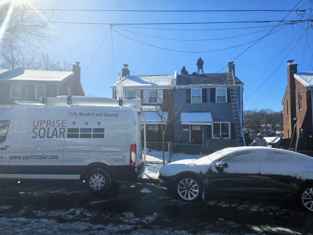 Uprise Solar installers work on a sunny winter day.